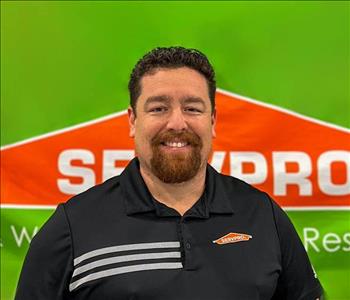 Man in front of SERVPRO wall