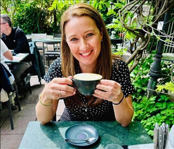 Lady enjoying a cup of coffee outdoors