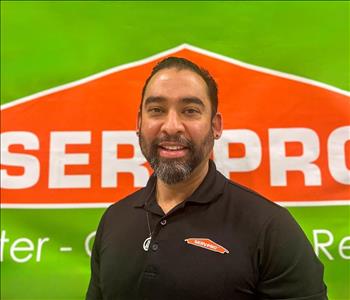 Man in front of SERVPRO wall