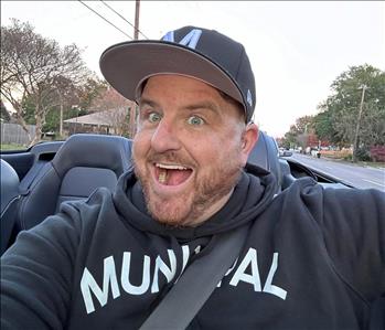 Man with a big smile enjoying a car ride