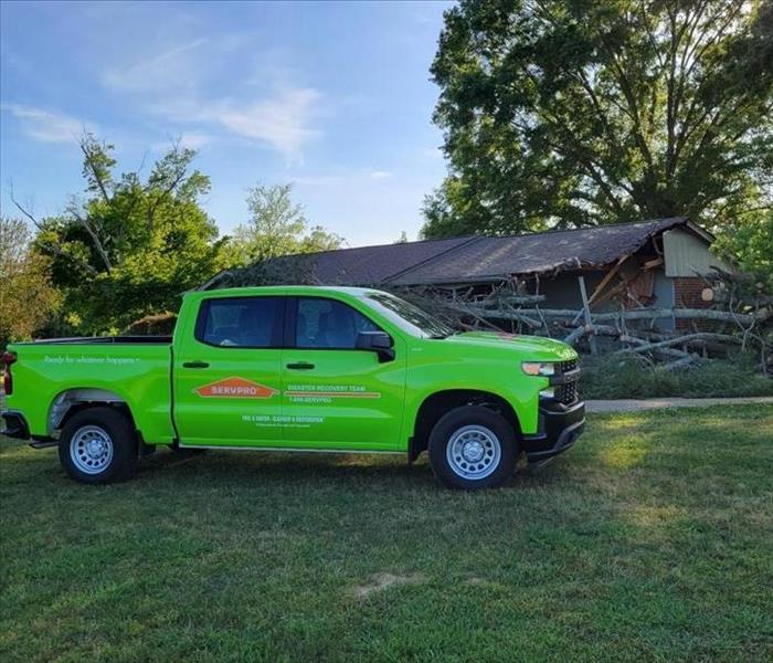 servpro truck in front of damaged home